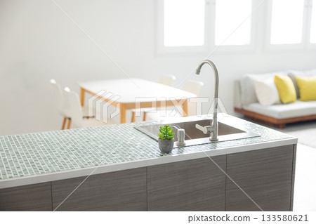 Interior with dining table and kitchen 133580621