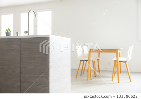 Interior with dining table and kitchen Interior with dining table and kitchen 133580622