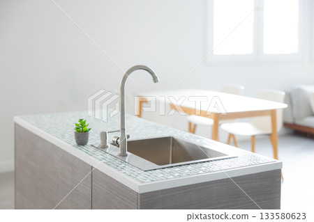 Interior with dining table and kitchen 133580623