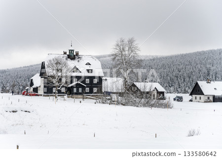 Winter in Jizera Mountains. Cloudy evening in Jizerka Village, Czech Republic 133580642