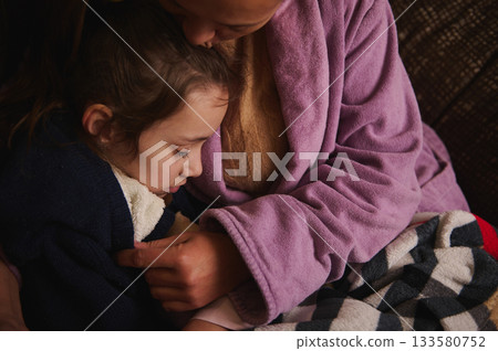 Mother And Child Embrace In Cozy Blanket: Warm Family Moment Of Comfort And Bonding Mother And Child Embrace In Cozy Blanket: Warm Family Moment Of Comfort And Bonding 133580752