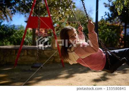 Joyful Girl On Swing In Park On Sunny Autumn Day Joyful Girl On Swing In Park On Sunny Autumn Day 133580841