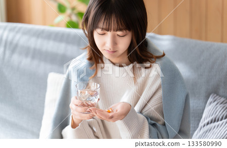Cold season, unwell woman taking medicine Cold season, unwell woman taking medicine 133580990