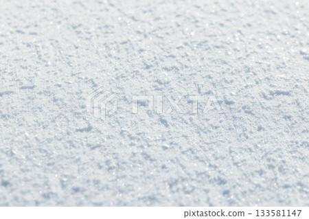 White snow surface shines in sunlight. Close up photography, 133581147