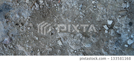 Close-up of a gray-black lava texture on the ground. Porous, cracked, and stony, perfect as a stock texture or photo background. Impression of molten rock. 133581168