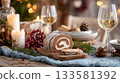 Festive table scene featuring a half-eaten buche de noel, candles, wine glasses, and holiday decorations creating a warm Christmas atmosphere 133581392
