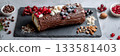 Buche de Noel on slate board with fresh berries and nuts, showcasing a festive holiday dessert in a minimalist composition for Christmas celebrations 133581403