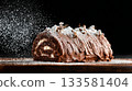 Classic chocolate buche de noel on a dark surface, dusted with powdered sugar, showcasing holiday elegance and festive culinary tradition 133581404