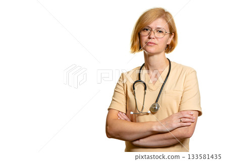 A female doctor or healthcare worker with her arms crossed and a stethoscope. 133581435
