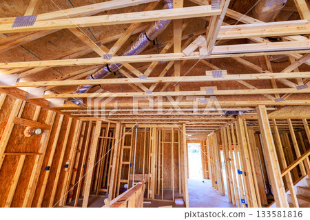 Inside view of home under construction showing wooden framing ventilation ducts 133581816