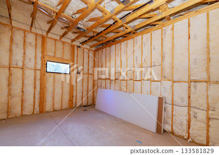 Construction work features insulation wooden framework in room, building stages. 133581829