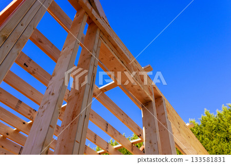Wooden beams frame construction under building process materials used. Wooden beams frame construction under building process materials used. 133581831