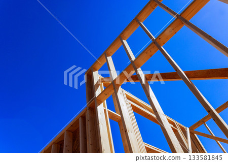 Wooden beams frame for house is being built progress in residential construction. 133581845