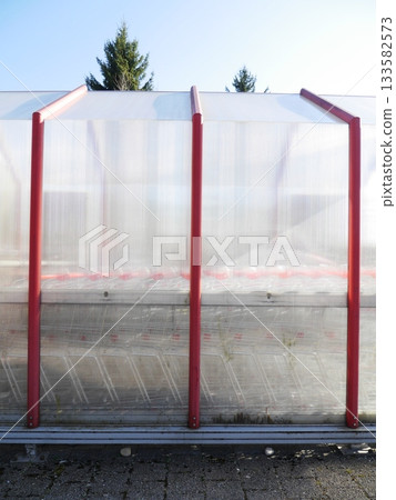 Shopping carts outside behind a glass wall Shopping carts outside behind a glass wall 133582573