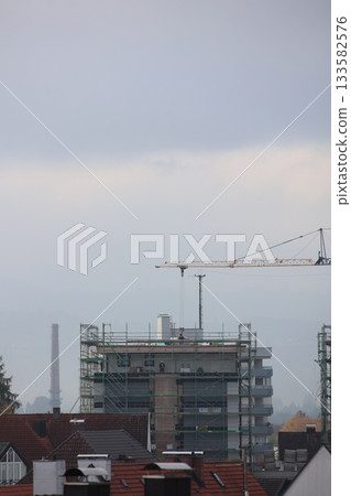 Crane is lifting a large building Crane is lifting a large building 133582576