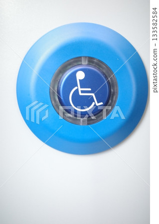 Blue button with a wheelchair symbol on it Blue button with a wheelchair symbol on it 133582584
