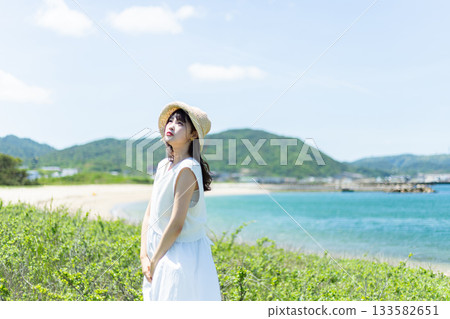 A woman relaxing on the coast A woman relaxing on the coast 133582651