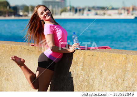 Woman with water after workout Woman with water after workout 133582849