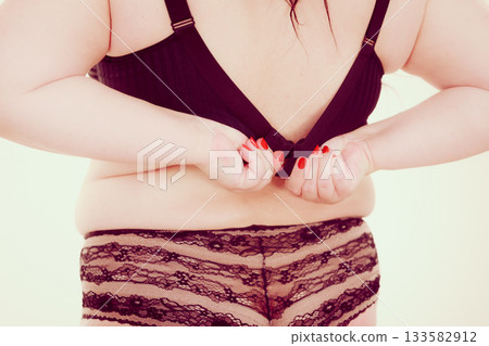 Fat woman in lingerie back view. Fat woman in lingerie back view. 133582912
