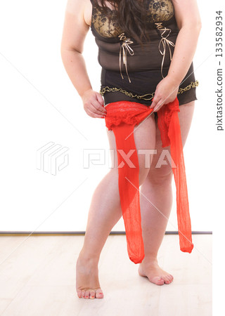 Woman plus size puts on red nylon stockings 133582934