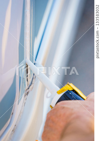 Applying silicon on caravan body 133583032
