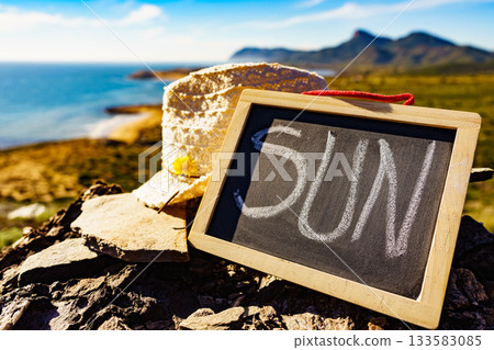 Black board with word sun against sea coast 133583085