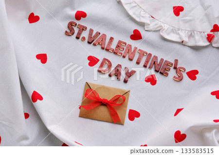 Festive St. Valentine's Day background of a white cotton blouse with hearts. 133583515