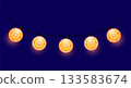 Glowing Orange Slice String Lights on Dark Blue Background 133583674
