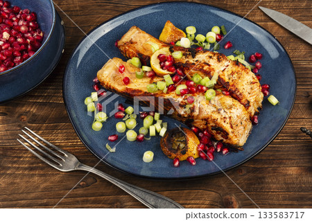 Appetizing fried fish steak on wooden surface. Appetizing fried fish steak on wooden surface. 133583717