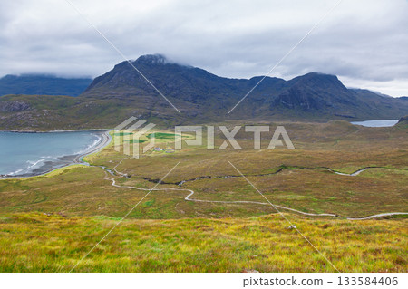 Hiking trail thru moorland below Cuillin mountains Isle of Skye Scotland Hiking trail thru moorland below Cuillin mountains Isle of Skye Scotland 133584406