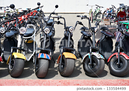Electric scooters for rent in parking 133584499
