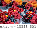 Prague, czech republic, august 9, 2023. Assortment of fresh organic berries including raspberries, blueberries, red currants, strawberries, and cherries in plastic containers at a market 133584601