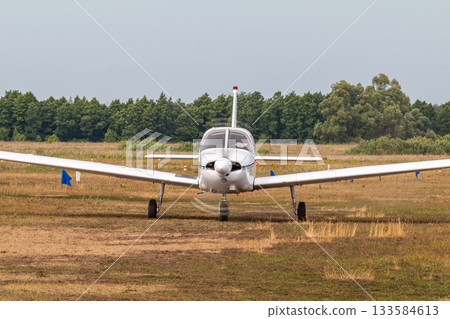 Front view of the private single-engined piston-powered aircraft taxiing at the airfield 133584613