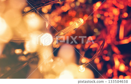 A photo of beautiful red and yellow electric lights. Fantastic illuminations. Winter. Bokeh effect. A photo of beautiful red and yellow electric lights. Fantastic illuminations. Winter. Bokeh effect. 133584638