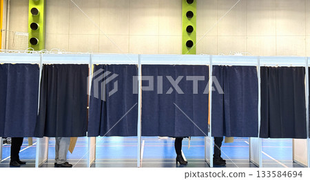 Voters inside curtained booths at polling station Voters inside curtained booths at polling station 133584694