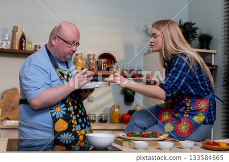 A Talented Culinary Duo Hard at Work Creating Delicious and Flavorful Dishes in the Kitchen A Talented Culinary Duo Hard at Work Creating Delicious and Flavorful Dishes in the Kitchen 133584865