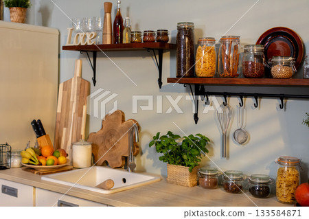 A modern kitchen with open shelves of fresh ingredients, inviting culinary creativity A modern kitchen with open shelves of fresh ingredients, inviting culinary creativity 133584871