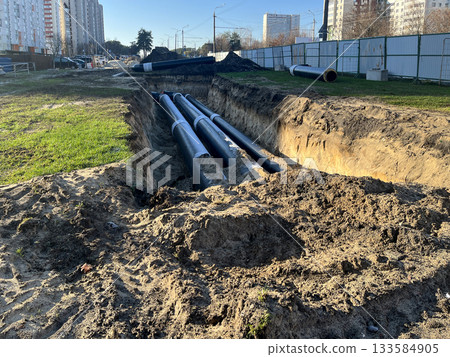 Urban heating pipeline construction trench in residential district Urban heating pipeline construction trench in residential district 133584905