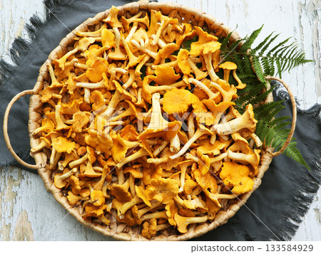 Organic Fresh chanterelle on a wood table. 133584929
