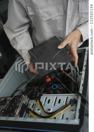 Closeup hand of computer hardware technician dissemble and fixing computer PC. Closeup hand of computer hardware technician dissemble and fixing computer PC. 133585134
