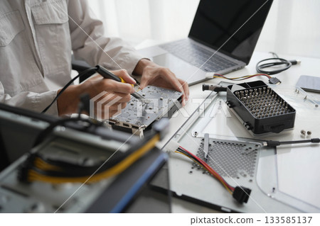 Closeup hand of computer hardware technician dissemble and fixing computer PC. Closeup hand of computer hardware technician dissemble and fixing computer PC. 133585137