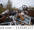 abandoned corrugated roofing remnants, dispersed stormdamaged metal sheets over field, weathered roofing panels strewn across open field exhibiting signs of neglect and deterioration 133585177