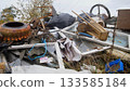 collection of construction waste including roofing and metal drums available now, wide assortment of construction debris like roofing sheets and metal drums prepared for transfer 133585184