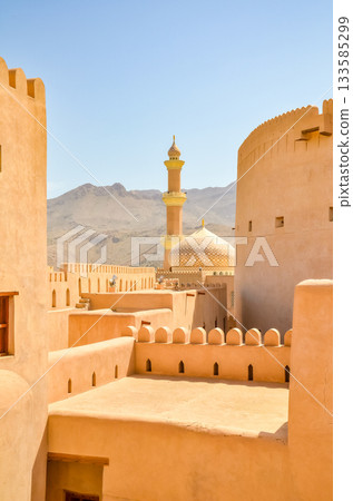 Nizwa Fort with mosque minaret, traditional architecture in Oman 133585299