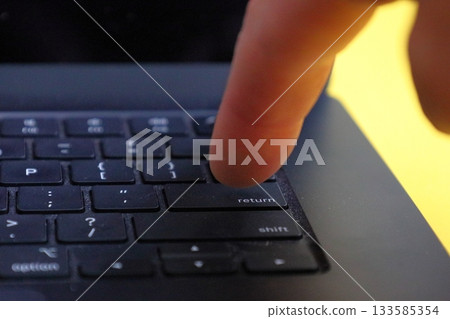 Finger Pressing Laptop Return Key 133585354