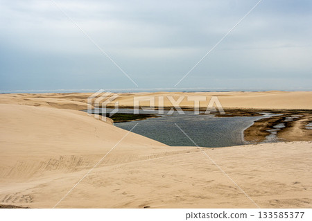 Dunes and lagoons of Atins, Lencois Maranhenses, Barreirinhas, Brazil. White sand dunes with pools of fresh water Dunes and lagoons of Atins, Lencois Maranhenses, Barreirinhas, Brazil. White sand dunes with pools of fresh water 133585377
