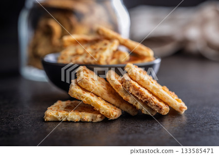 Crunchy salted crackers on black table. 133585471