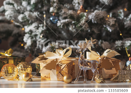 Crystal Reindeer with Gold Antlers and Christmas Gifts in Festive Interior 133585609