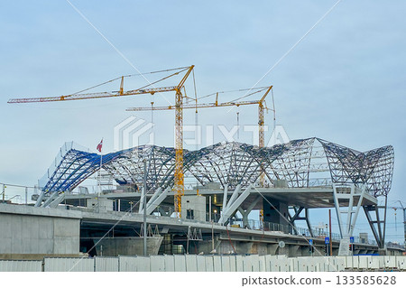 Rail Baltic station construction with cranes and steel roof structure in Riga, Latvia Rail Baltic station construction with cranes and steel roof structure in Riga, Latvia 133585628