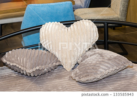 Decorative soft pillows on bed 133585943